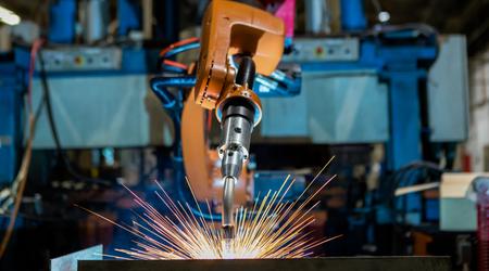 Robot is welding assembly automotive part in car factory