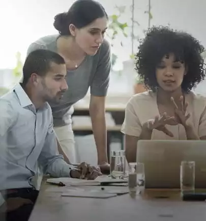 curly hair women sharing her idea to her teammate looking at the laptop